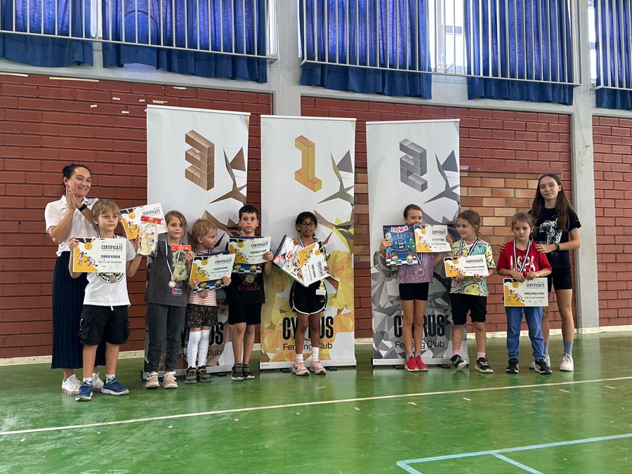 Kids with medals and certificates at a club tournament